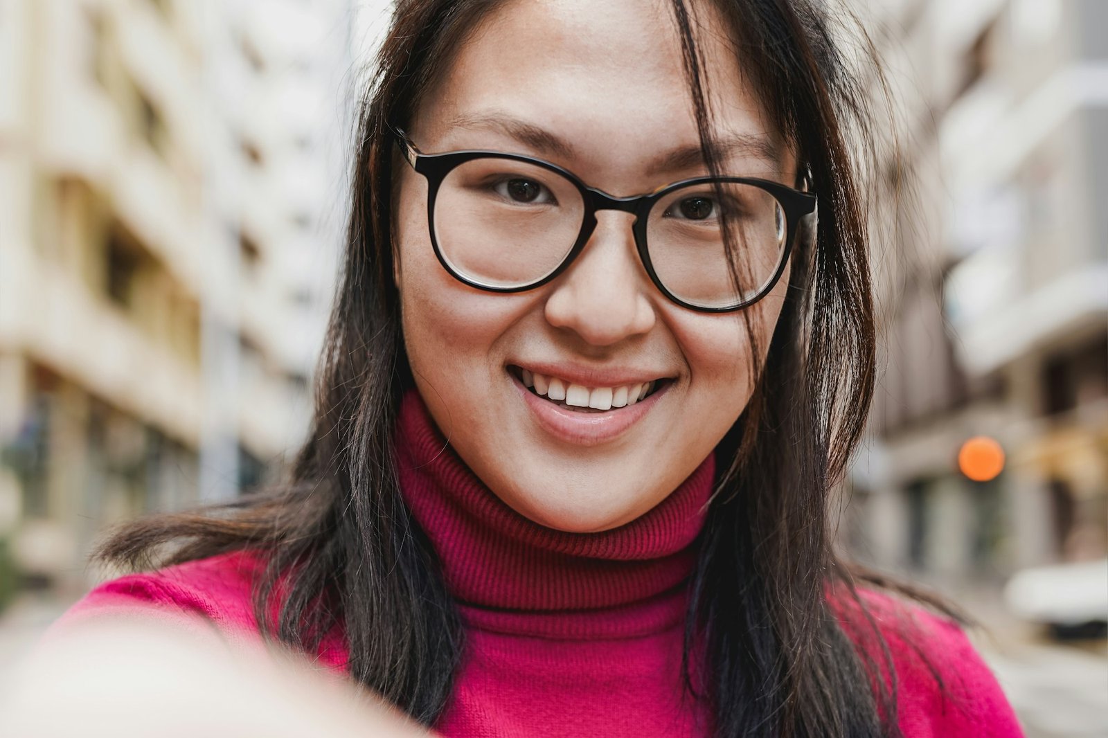 Young asian girl taking a selfie in the city